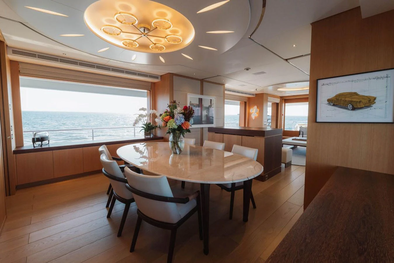 The yacht's dining area features a large table with elegant seating and panoramic ocean views. aboard GRAYCLIFFS Yacht for Sale