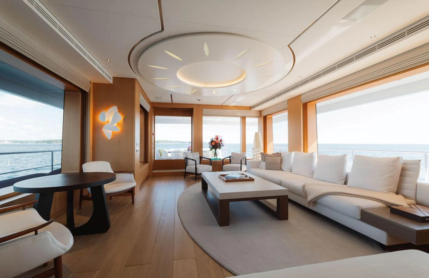 The salon features elegant furnishings with ample natural light and panoramic views. aboard GRAYCLIFFS Yacht for Sale