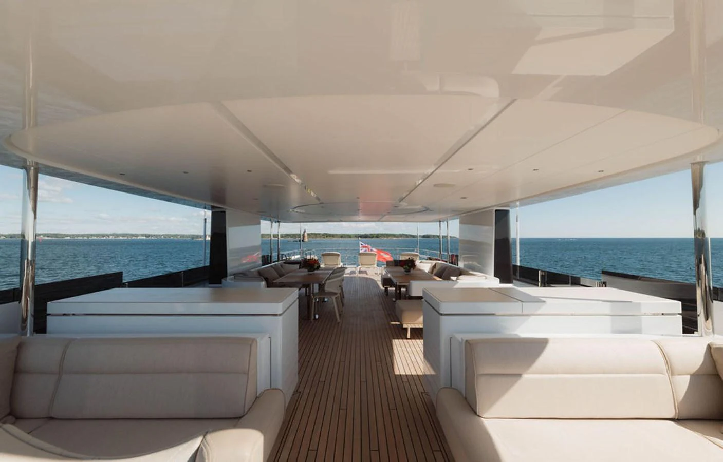 The aft deck offers a spacious and shaded area with comfortable seating and stunning ocean views. aboard GRAYCLIFFS Yacht for Sale