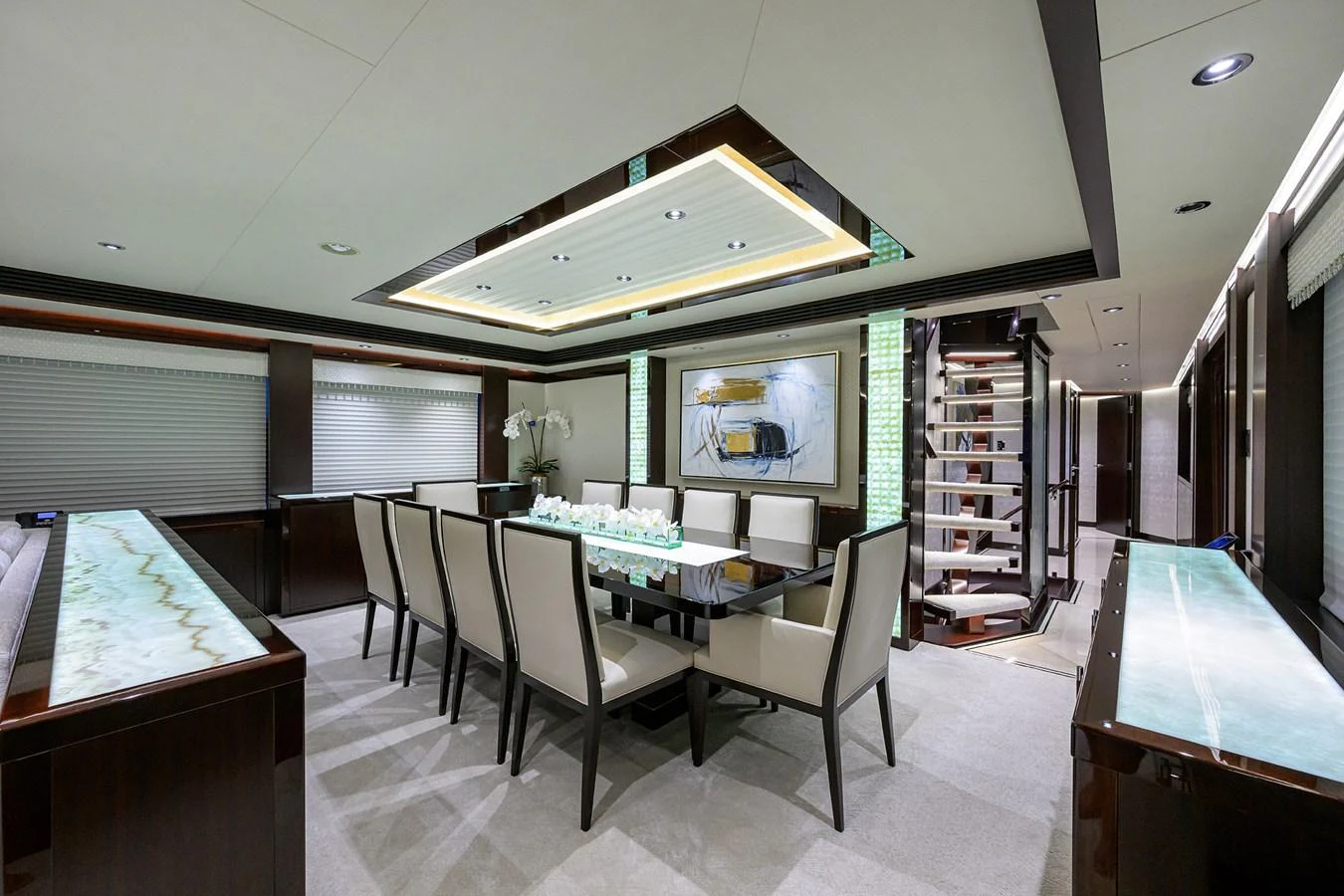 a room with a table chairs and a tv aboard RENNEGADE Yacht for Sale