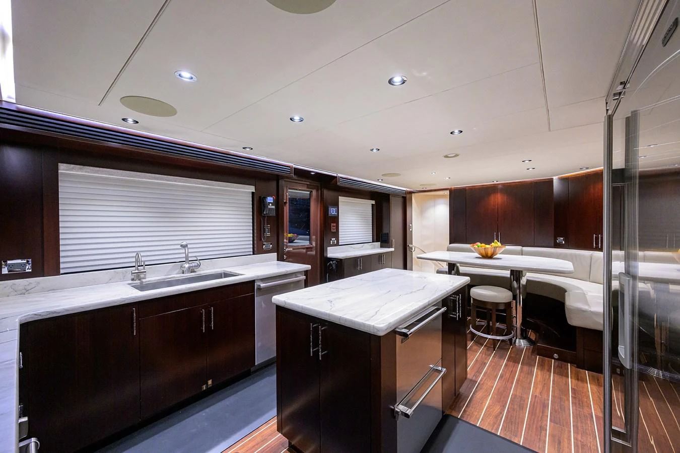 a kitchen with a table and chairs aboard RENNEGADE Yacht for Sale