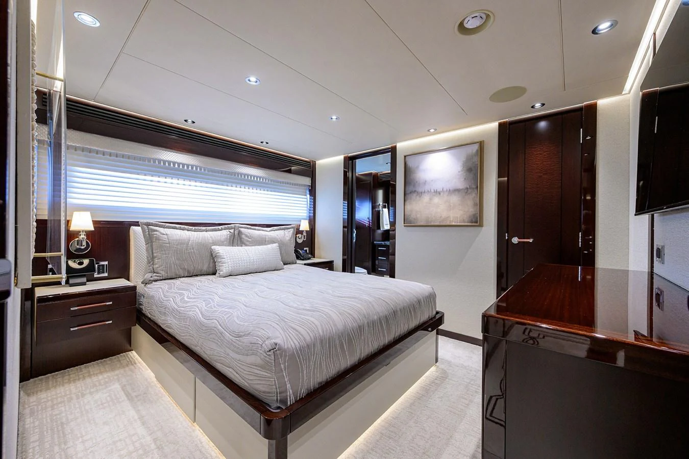 a bedroom with a bed and a desk aboard RENNEGADE Yacht for Sale