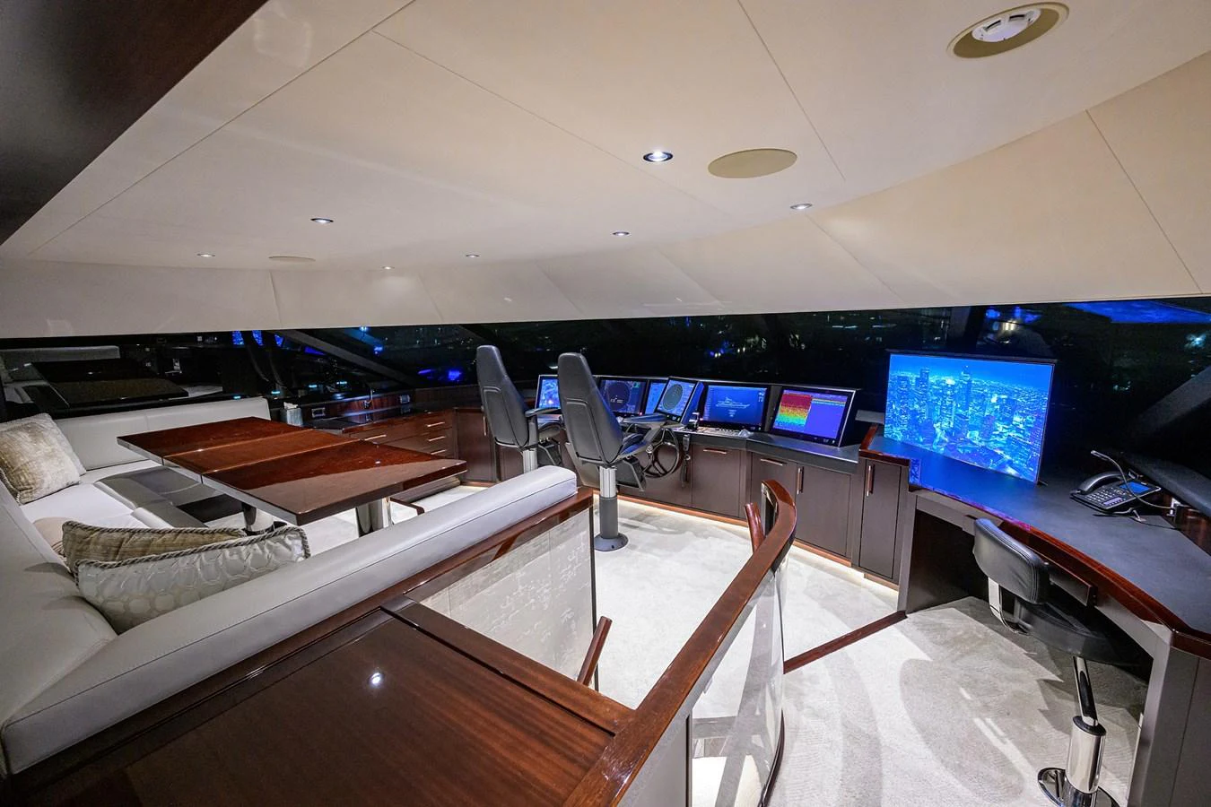 a room with a couch and a tv on the wall aboard RENNEGADE Yacht for Sale