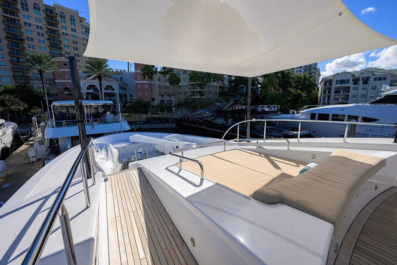 a deck with a boat and buildings in the background aboard RENNEGADE Yacht for Sale