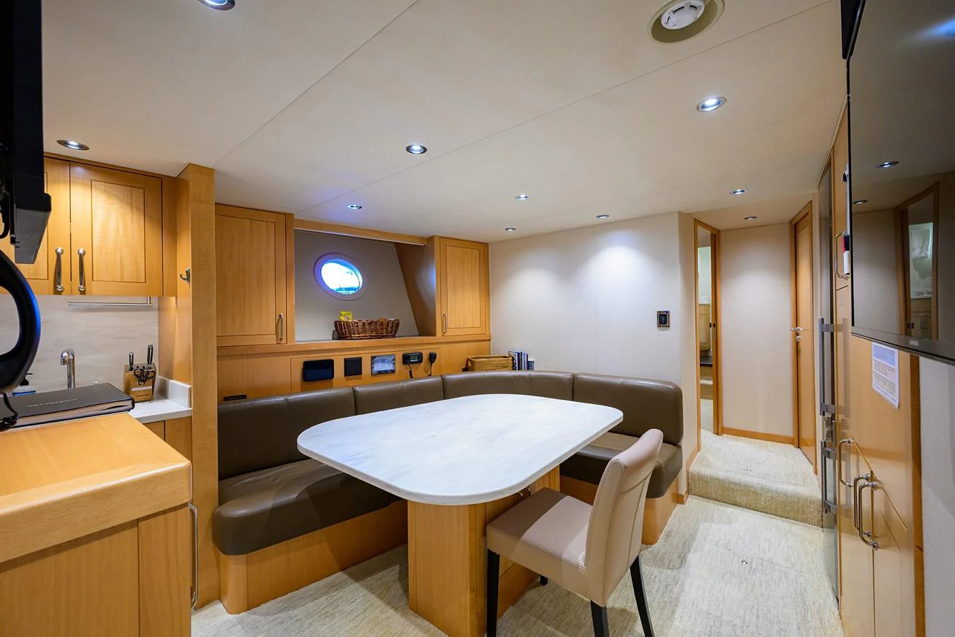 a kitchen with a table and chairs aboard RENNEGADE Yacht for Sale