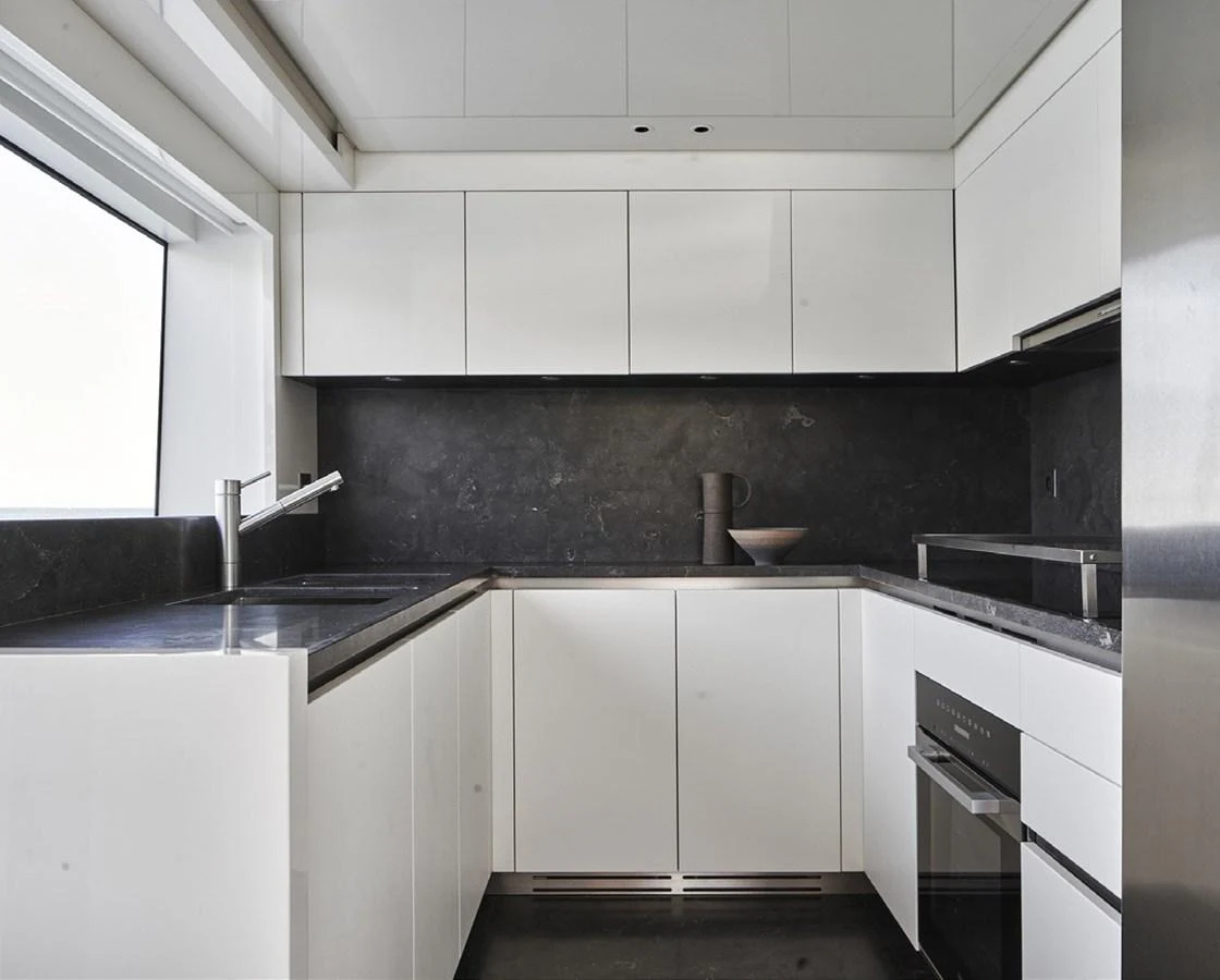 a kitchen with white cabinets aboard SIXTYFIVE Yacht for Sale