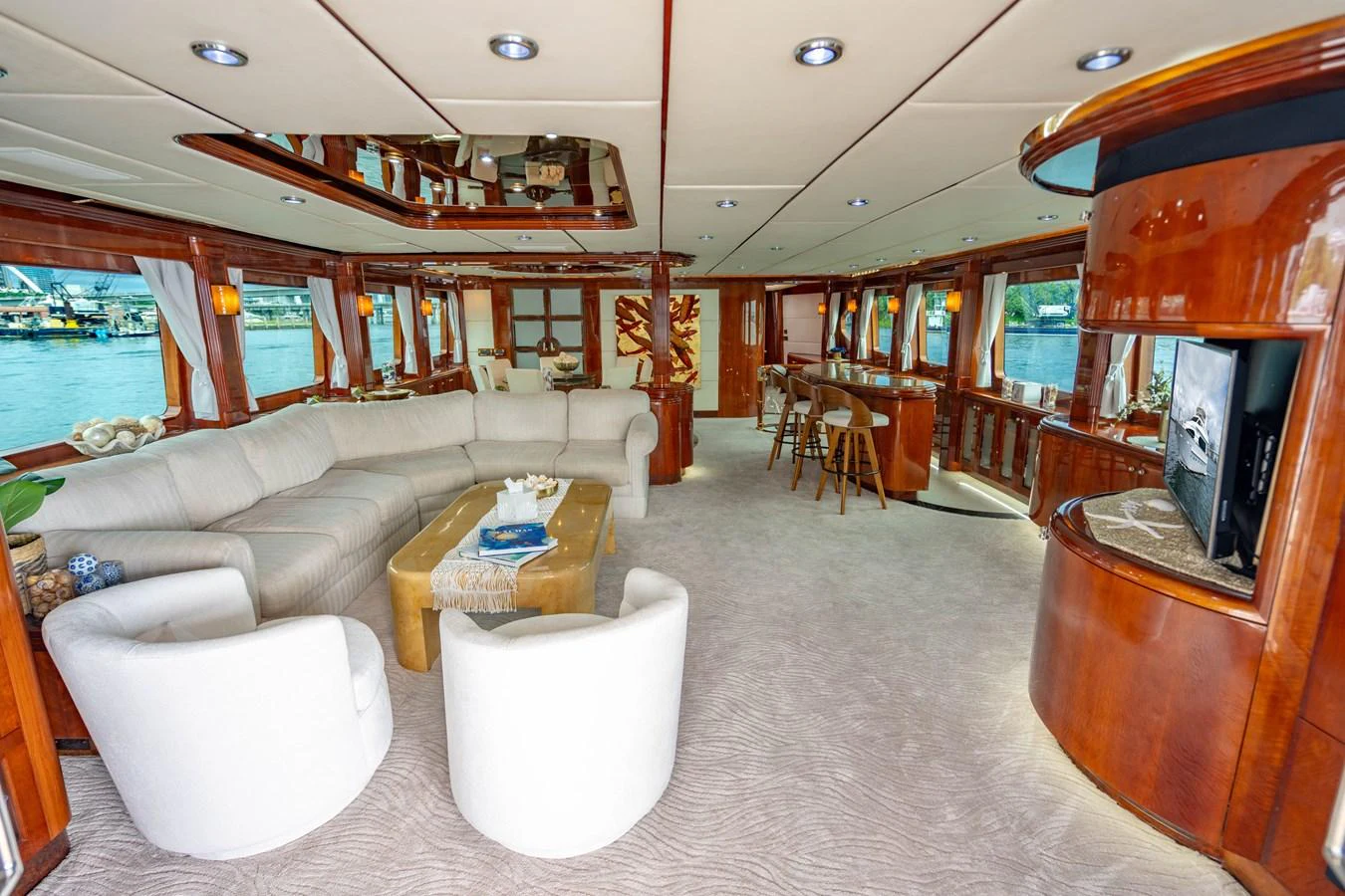 a living room with a couch and a television aboard AQUA Yacht for Sale