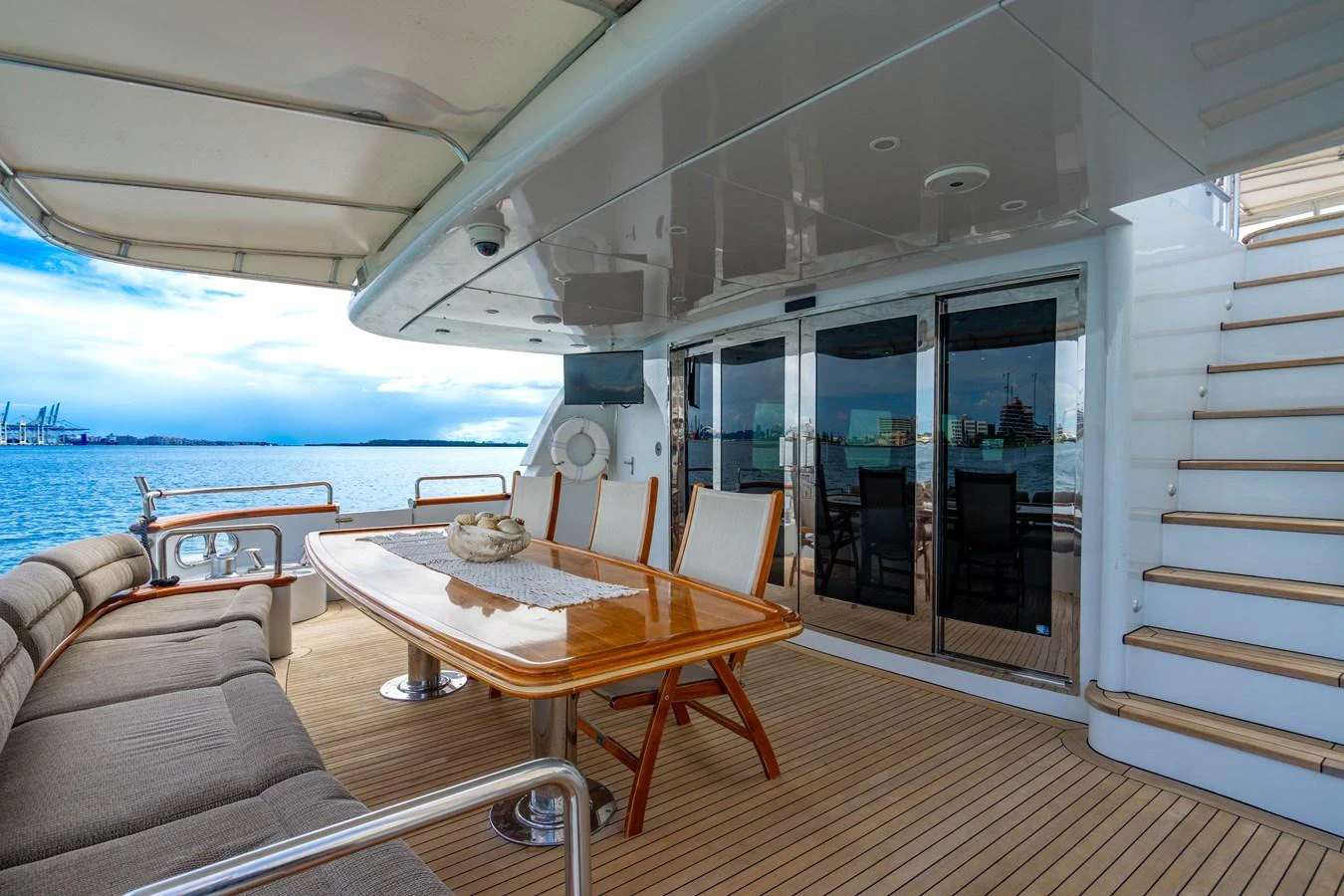 a table and chairs on a deck aboard AQUA Yacht for Sale