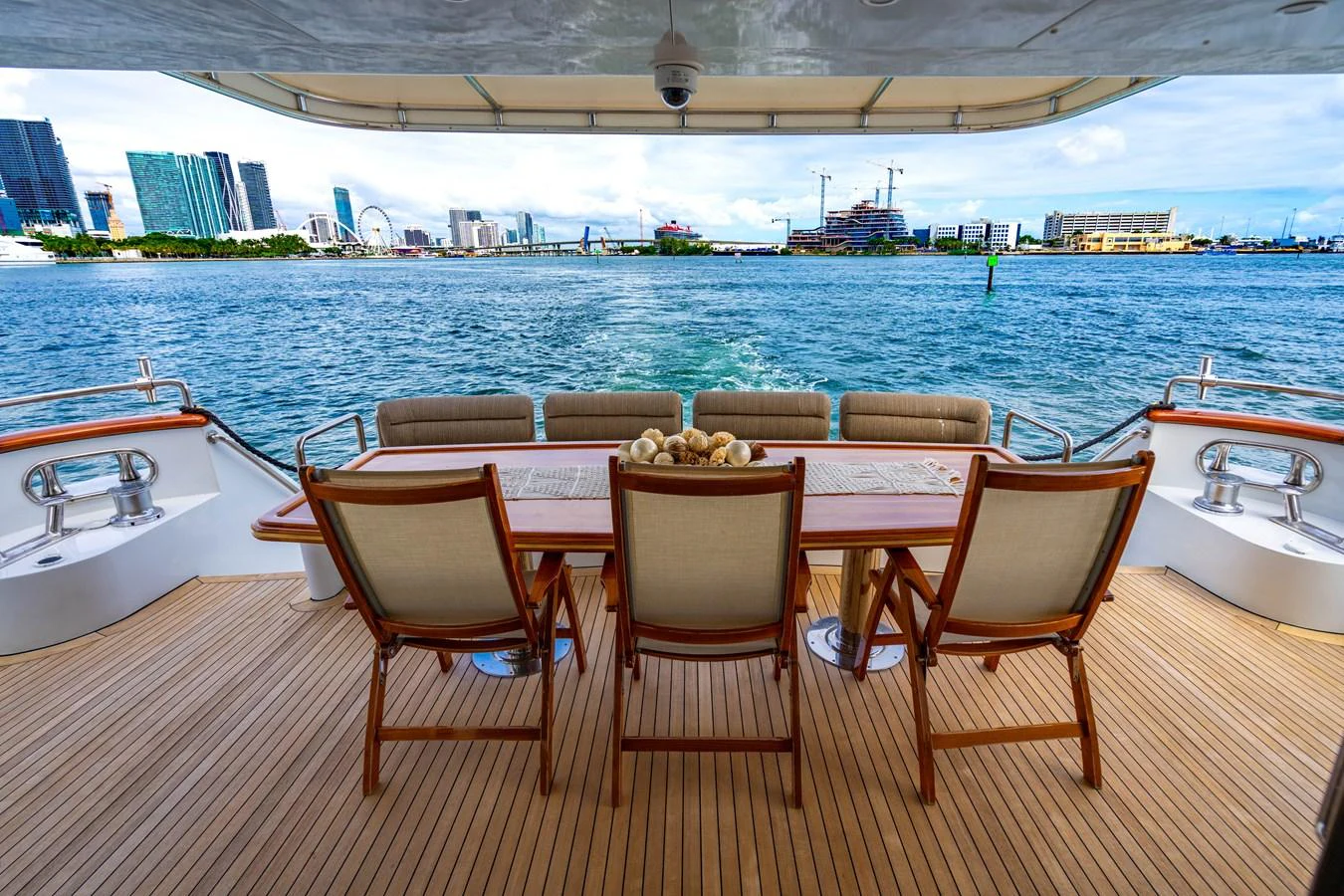 a table and chairs on a deck aboard AQUA Yacht for Sale
