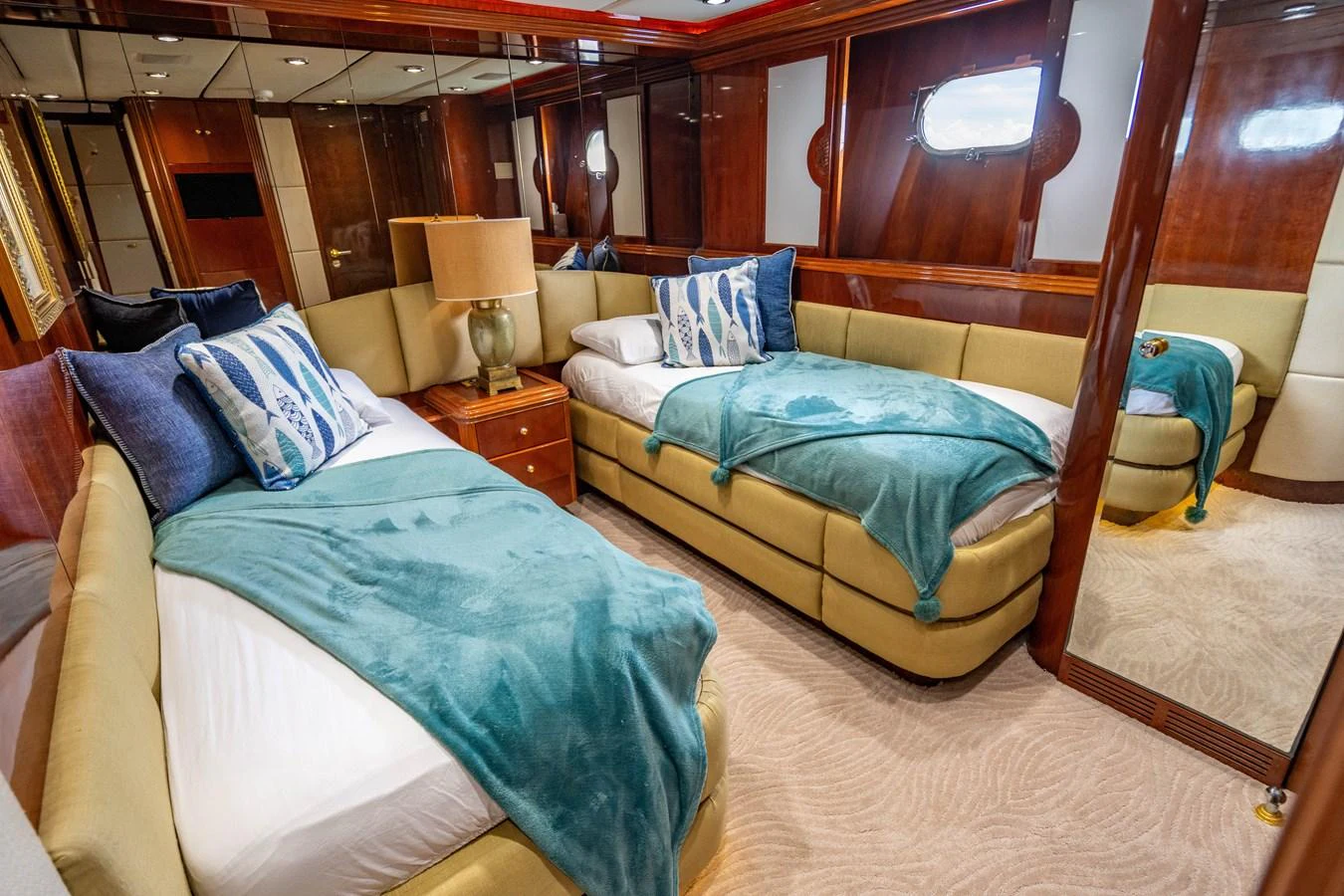 a bedroom with a bed and a lamp aboard AQUA Yacht for Sale