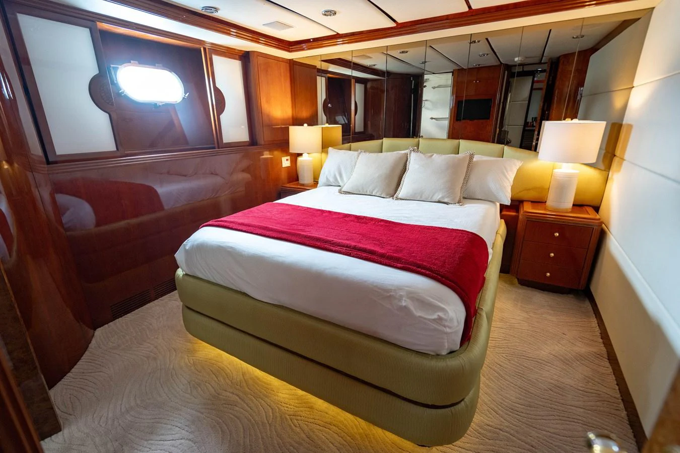 a room with a bed and a chair aboard AQUA Yacht for Sale