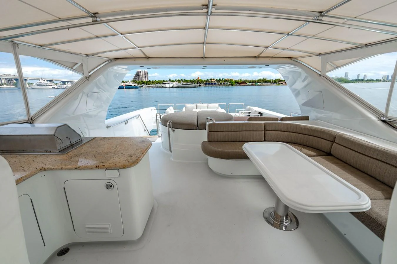 a room with a view of the ocean and a large boat aboard AQUA Yacht for Sale