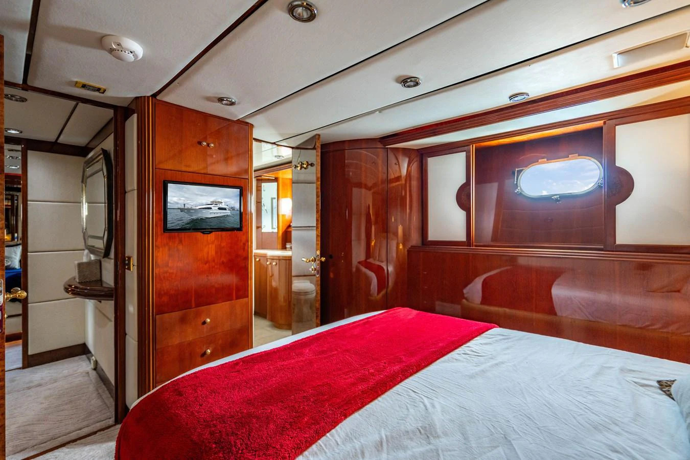 a room with a bed and a television aboard AQUA Yacht for Sale