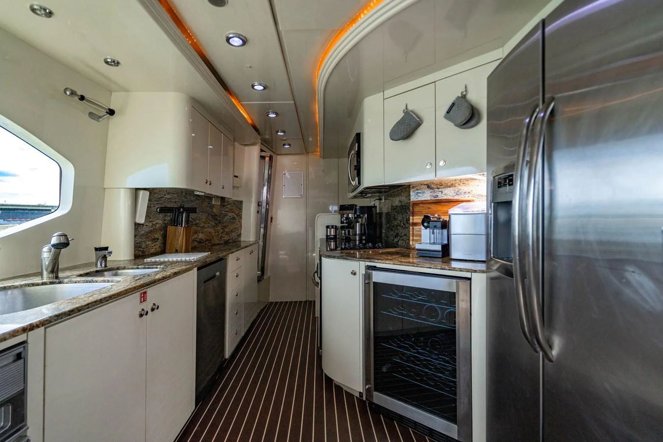 a kitchen with stainless steel appliances aboard AQUA Yacht for Sale