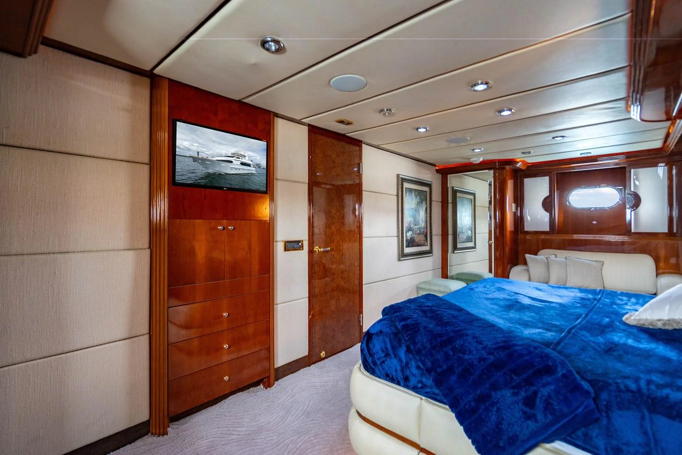 a room with a bed and a television aboard AQUA Yacht for Sale