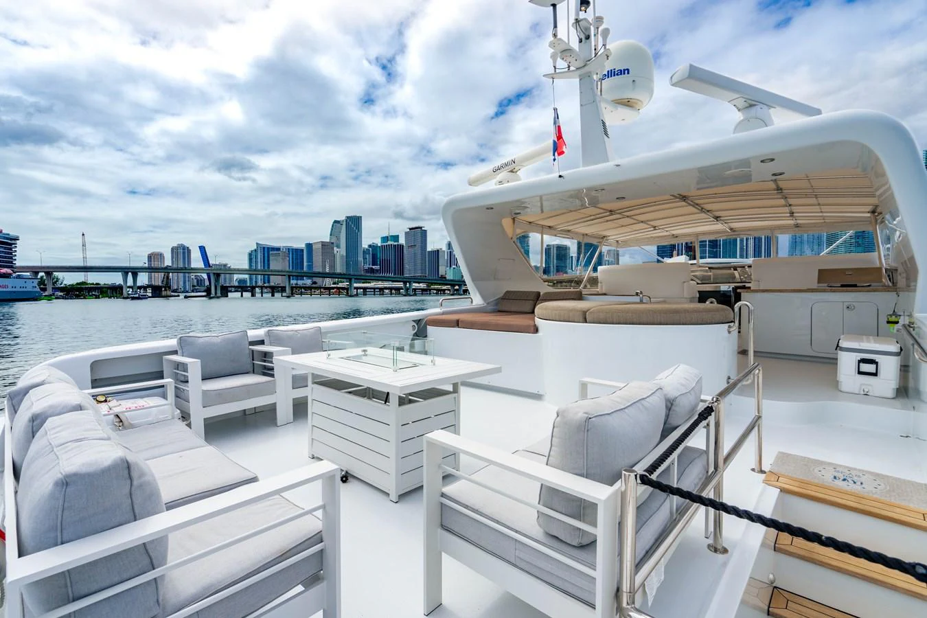 a deck with chairs and a boat on it aboard AQUA Yacht for Sale