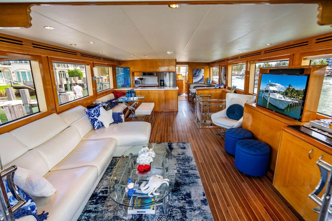 The yacht's salon features luxurious seating, a modern entertainment system, and elegant decor with ample natural light. aboard WATER BORN Yacht for Sale
