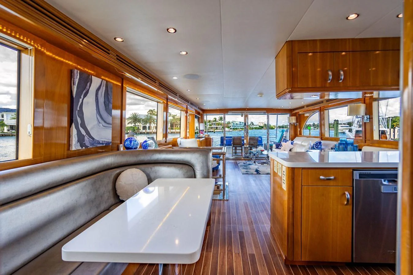 The salon features elegant wood finishes, a comfortable seating area, and large windows offering stunning views. aboard WATER BORN Yacht for Sale