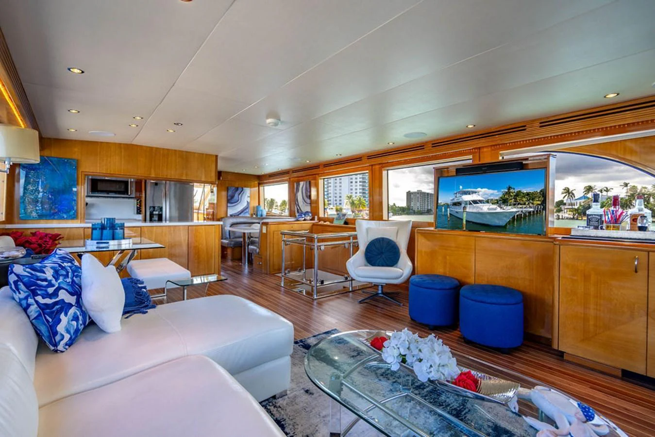 The yacht's salon features a spacious and elegant living area with modern furnishings and large windows. aboard WATER BORN Yacht for Sale