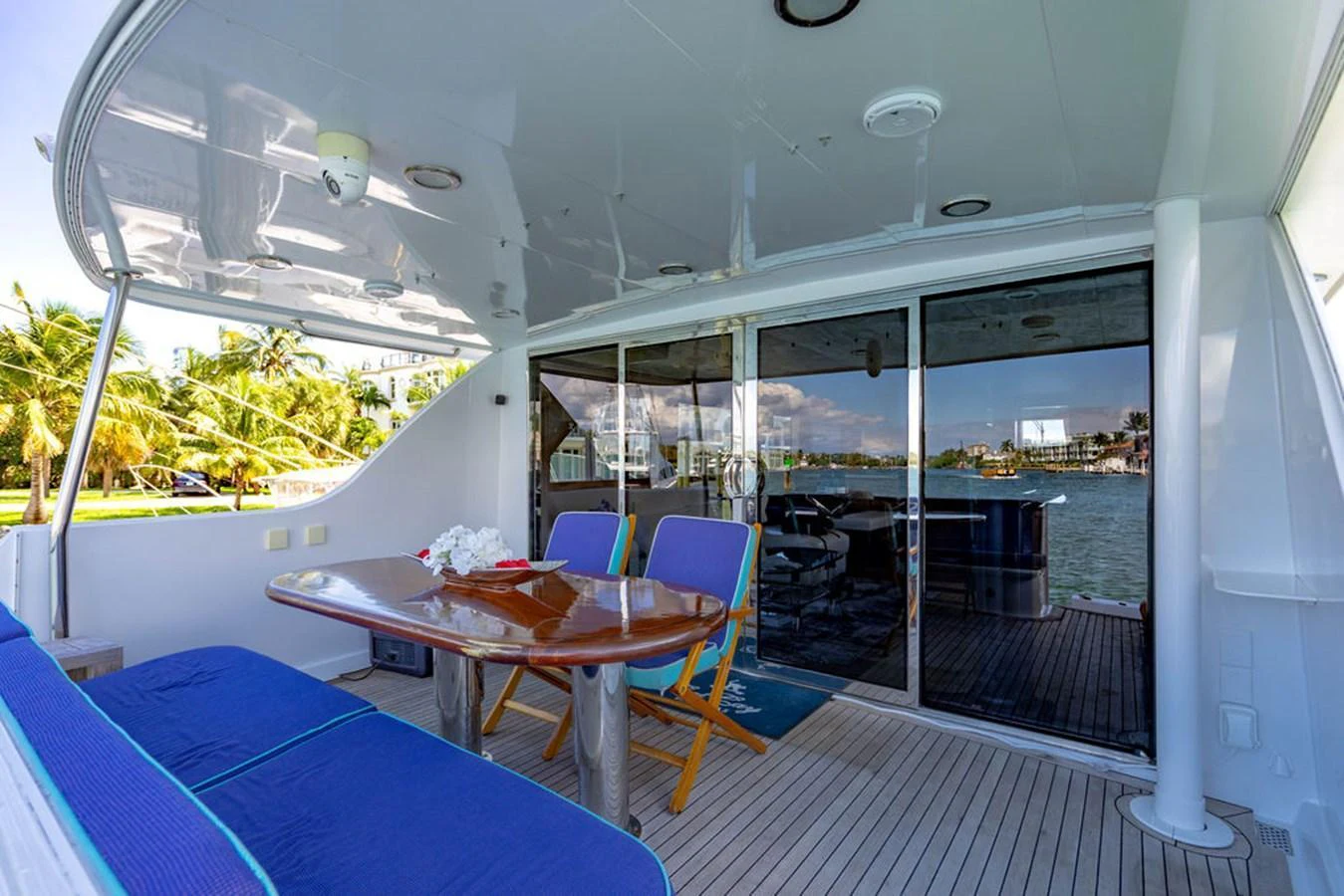 The aft deck features a comfortable seating area with a table, perfect for outdoor dining and relaxation. aboard WATER BORN Yacht for Sale