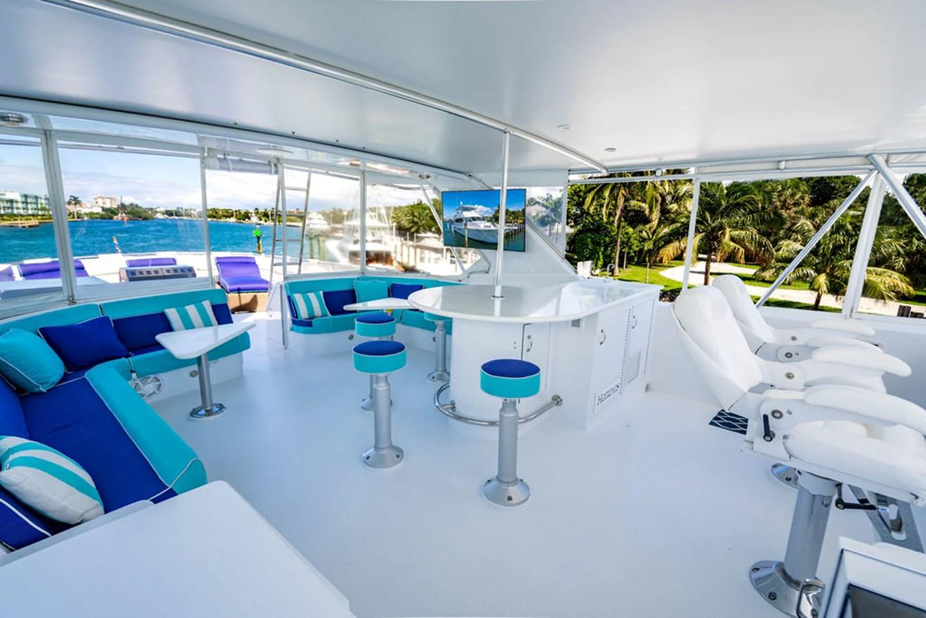 The flybridge offers a spacious and luxurious area with comfortable seating and a bar. aboard WATER BORN Yacht for Sale