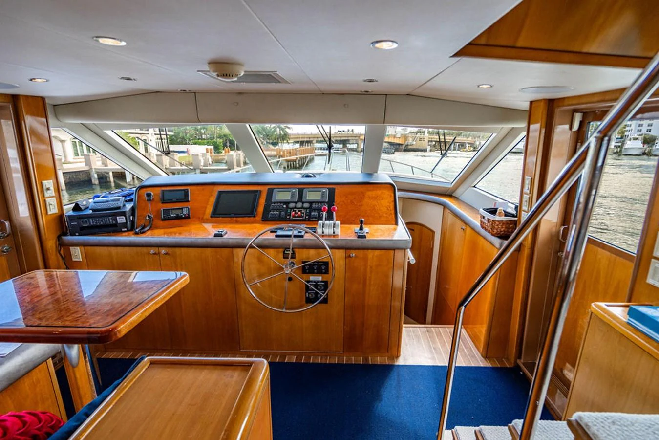 The helm station features a classic wooden design with modern navigation equipment and panoramic windows. aboard WATER BORN Yacht for Sale