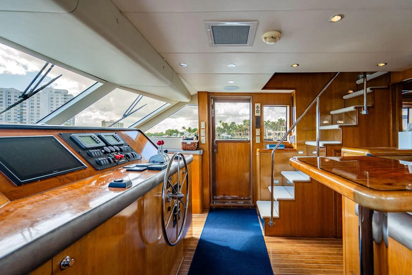 The helm station features a sleek design with modern navigation equipment and a polished wooden finish. aboard WATER BORN Yacht for Sale