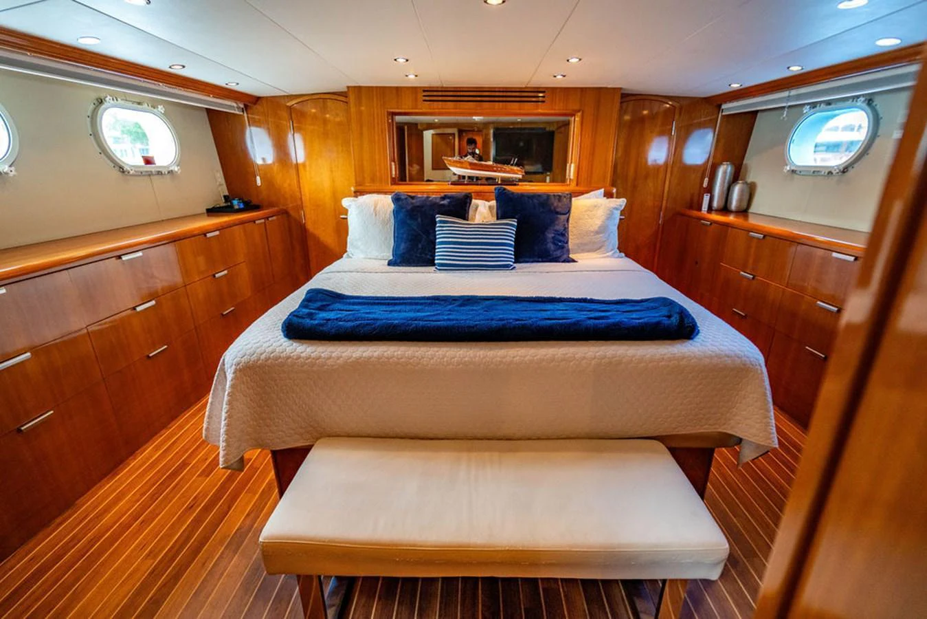 The master stateroom features a luxurious bed with elegant wood paneling and ample natural light. aboard WATER BORN Yacht for Sale