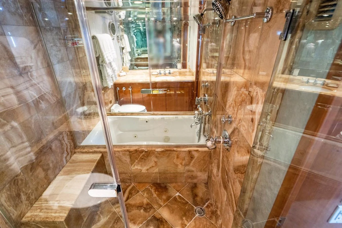 Luxurious bathroom with marble finishes and glass shower enclosure. aboard WATER BORN Yacht for Sale
