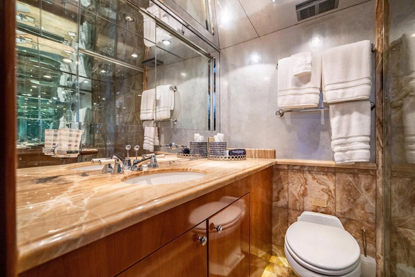 A luxurious yacht bathroom featuring elegant marble countertops and modern fixtures. aboard WATER BORN Yacht for Sale