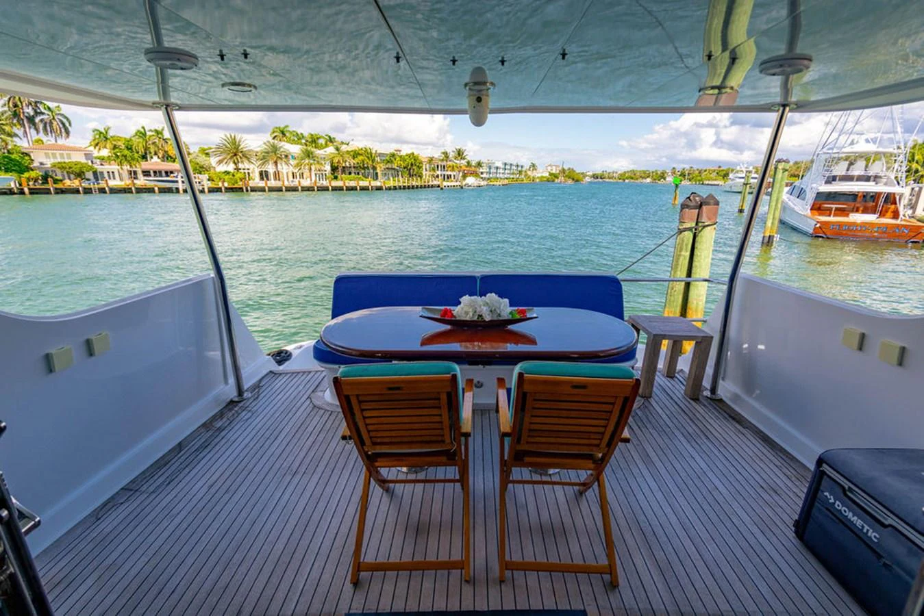 The aft deck offers a serene dining area with a beautiful view of the water. aboard WATER BORN Yacht for Sale