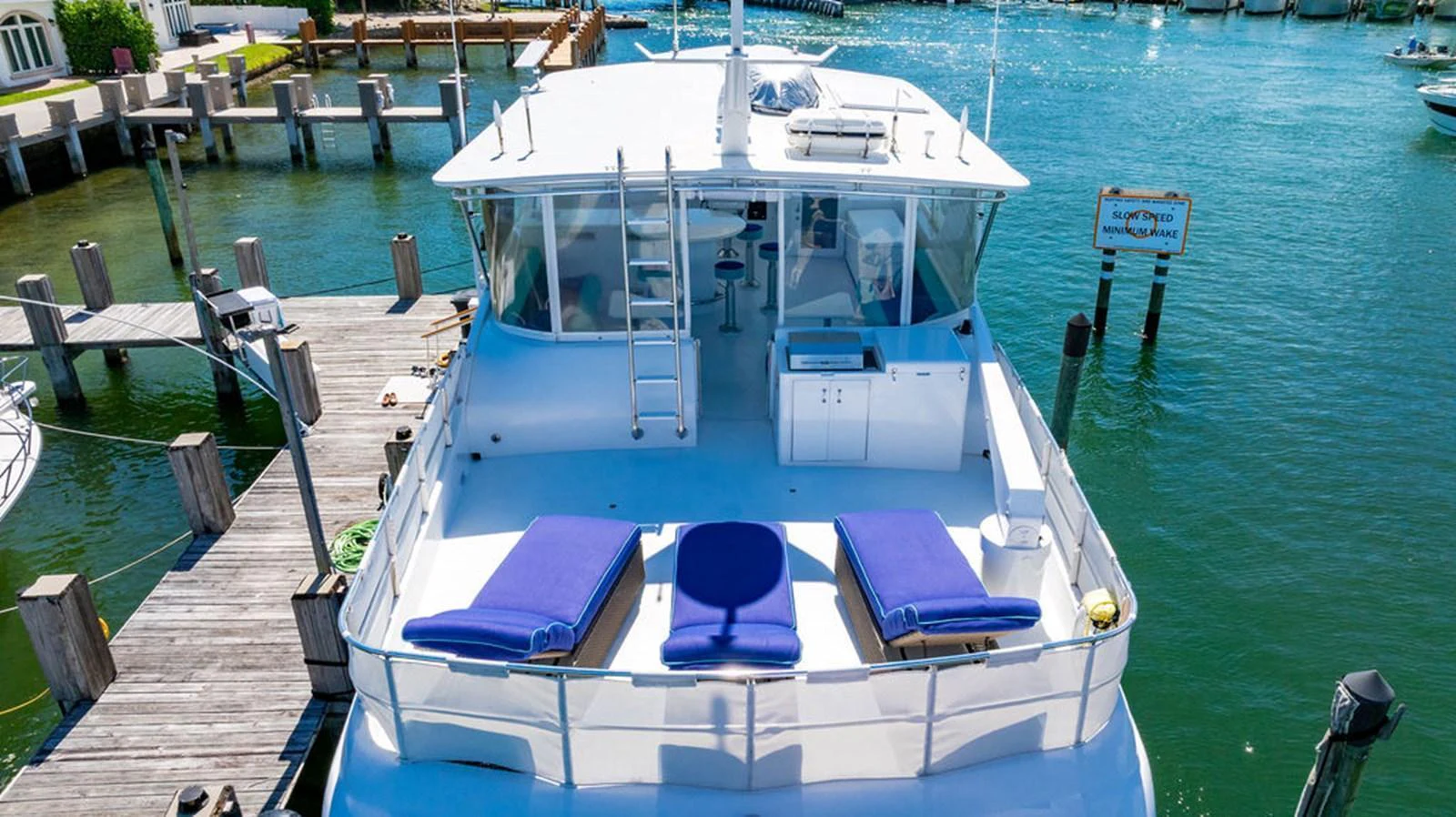 The yacht's aft deck offers a relaxing space with sun loungers and a view of the marina. aboard WATER BORN Yacht for Sale
