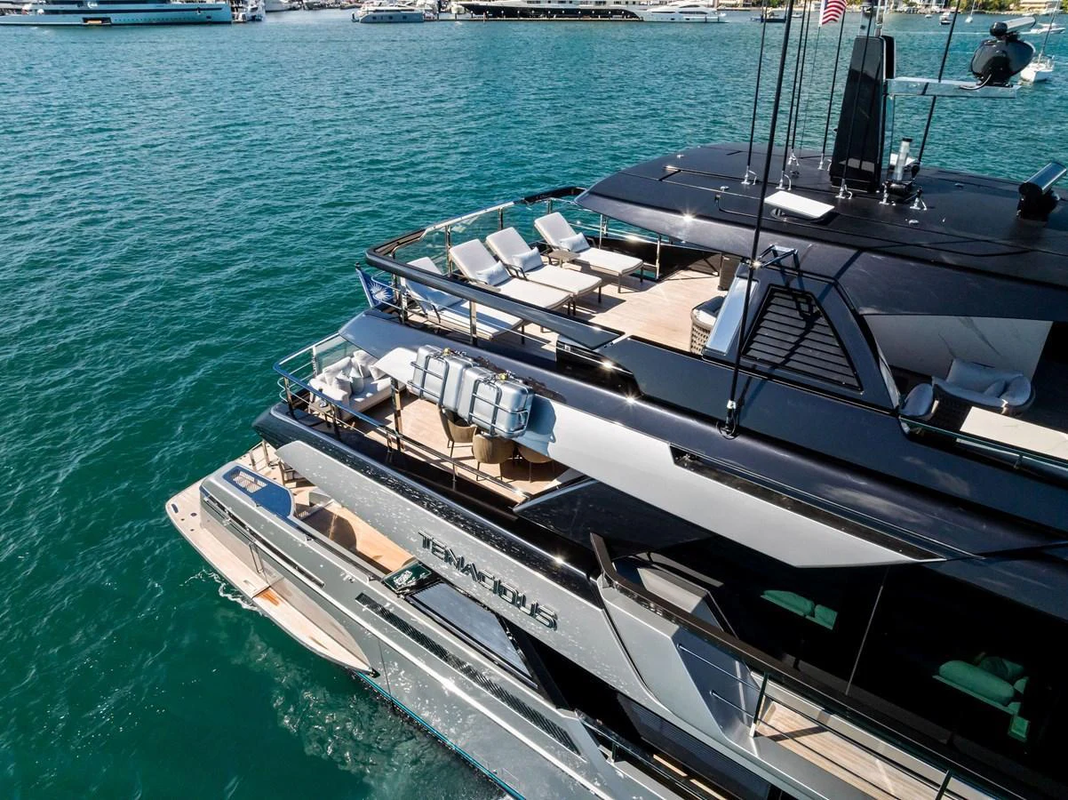 The yacht's sleek aft deck features luxurious seating and a modern design, perfect for relaxation and entertaining. aboard TENACIOUS Yacht for Sale