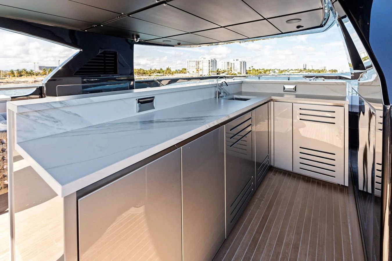 This sleek outdoor galley features modern cabinetry and a spacious countertop, perfect for alfresco dining and entertaining. aboard TENACIOUS Yacht for Sale