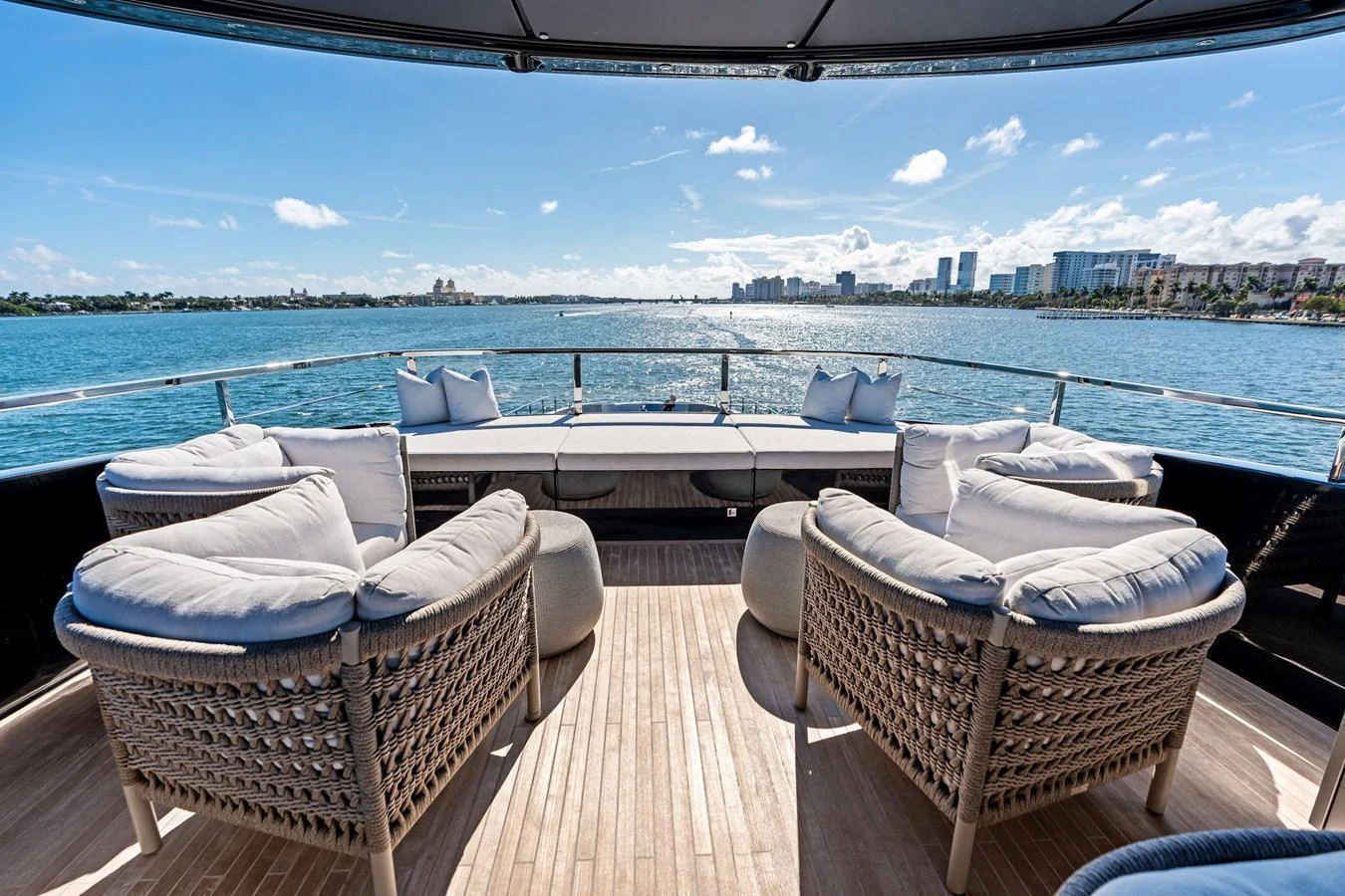 The aft deck offers a luxurious seating area with panoramic views of the water and skyline. aboard TENACIOUS Yacht for Sale