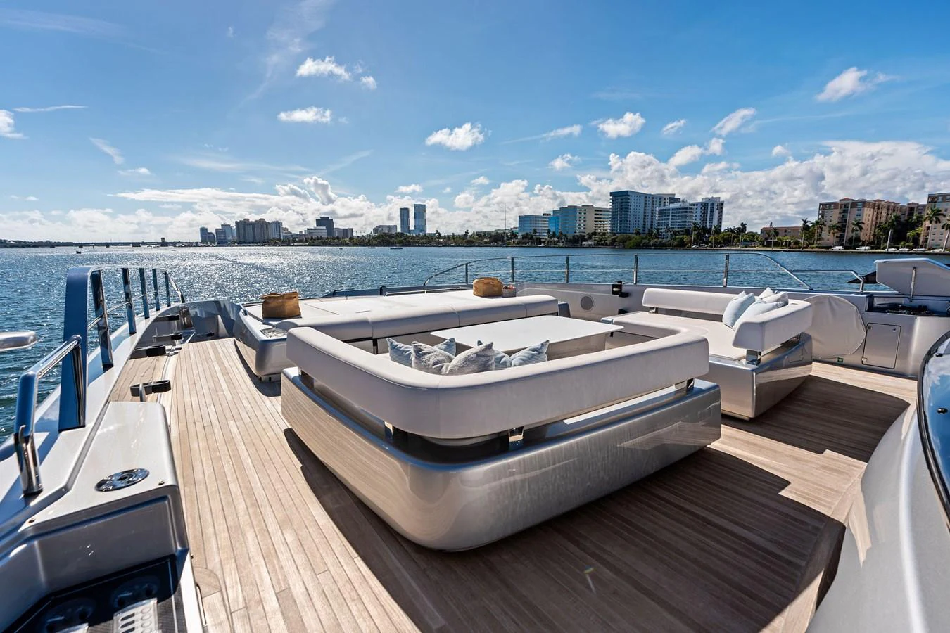 The sundeck offers a luxurious lounging area with stunning views of the water and city skyline. aboard TENACIOUS Yacht for Sale