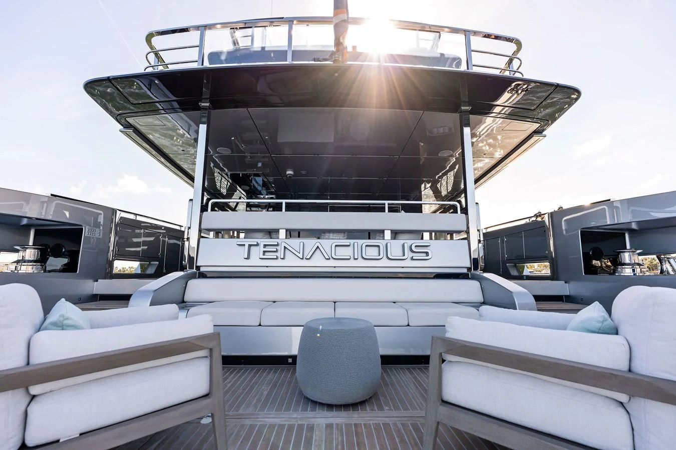 The aft deck of the yacht features comfortable seating and a stylish design, perfect for relaxation. aboard TENACIOUS Yacht for Sale
