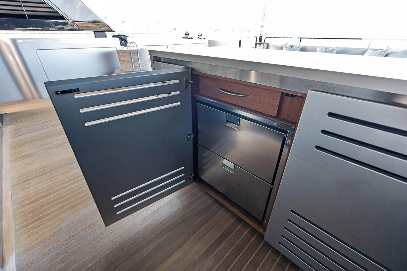 This image showcases a sleek, modern outdoor kitchen area on the yacht. aboard TENACIOUS Yacht for Sale