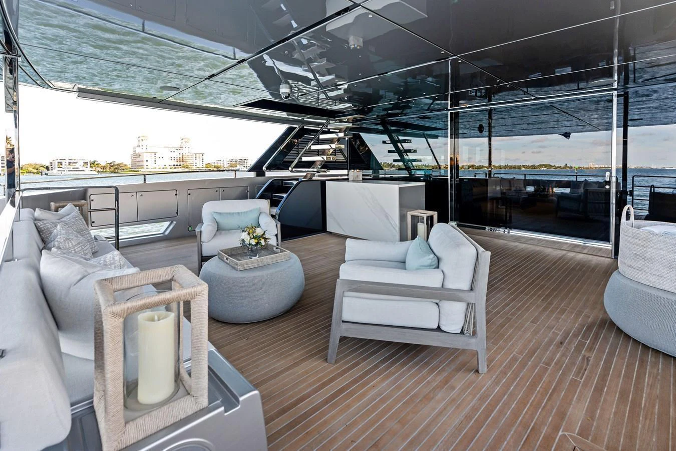 The aft deck features luxurious seating and a serene ambiance with a view of the water. aboard TENACIOUS Yacht for Sale