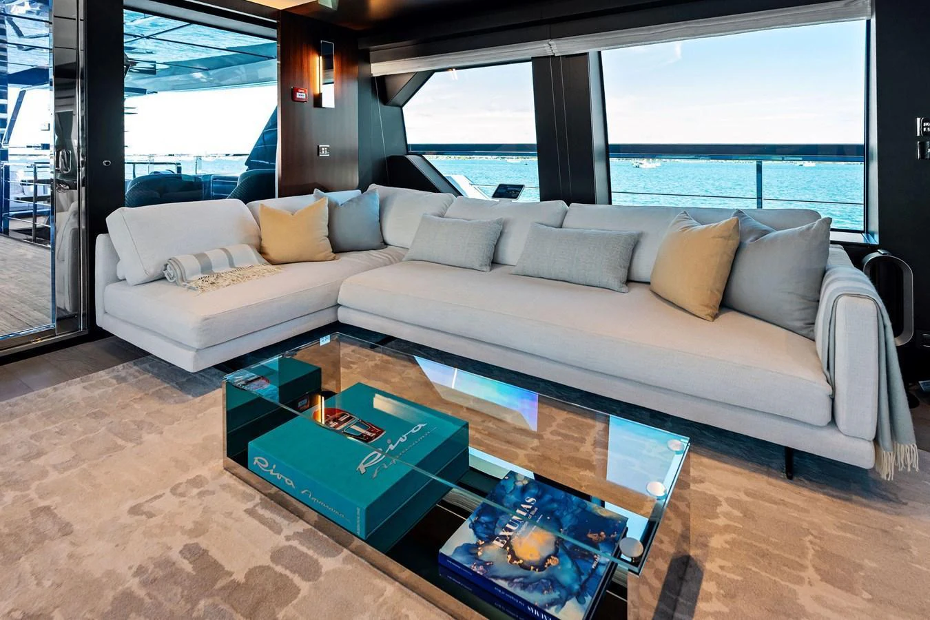 The salon features a spacious and elegant seating area with panoramic ocean views. aboard TENACIOUS Yacht for Sale