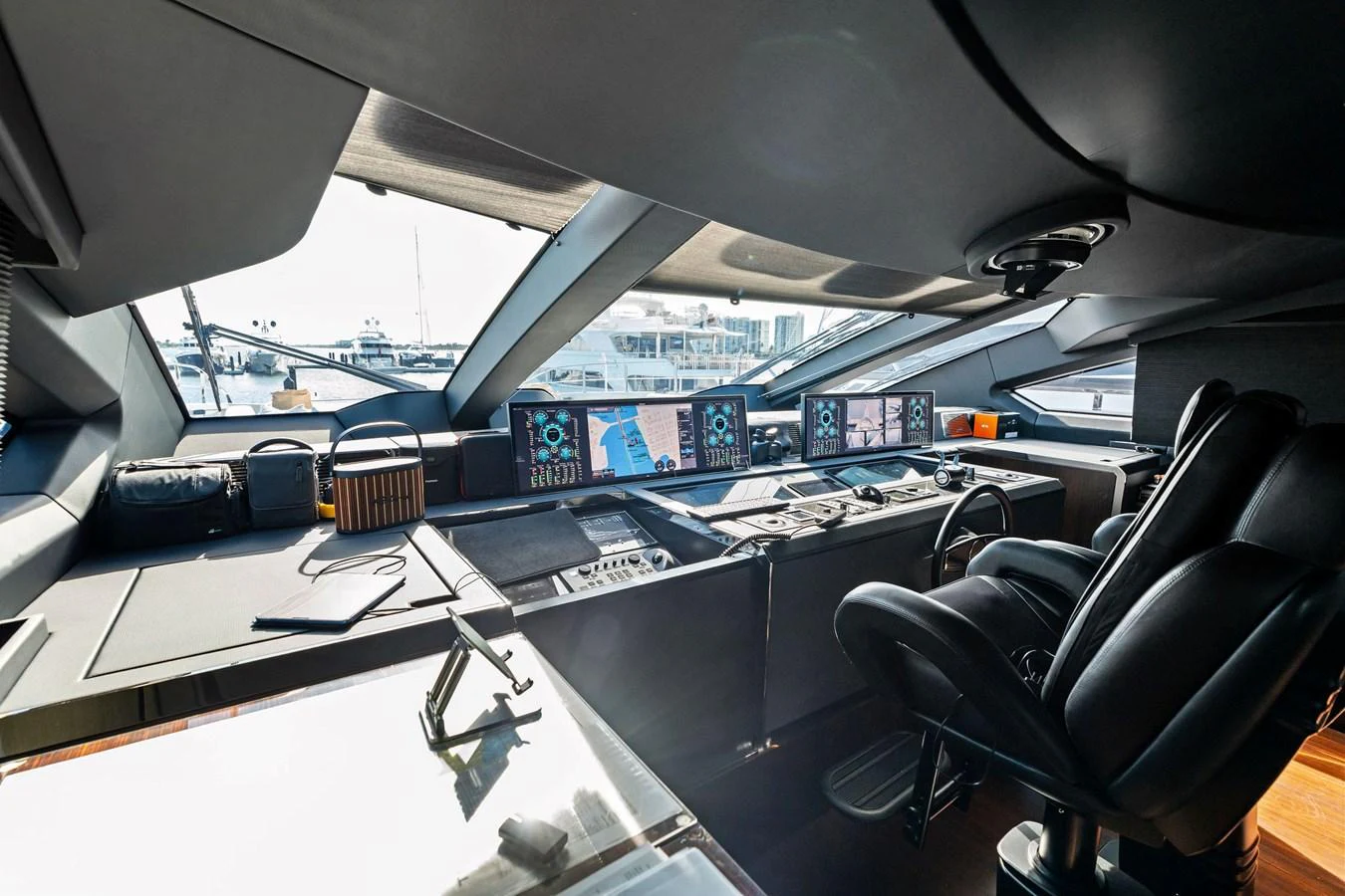The helm station features advanced navigation equipment and luxurious seating, offering a commanding view for the captain. aboard TENACIOUS Yacht for Sale