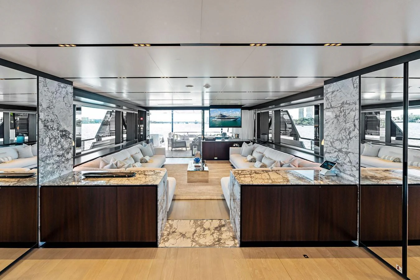 The spacious salon features luxurious seating and elegant marble accents, offering a sophisticated and comfortable environment. aboard TENACIOUS Yacht for Sale
