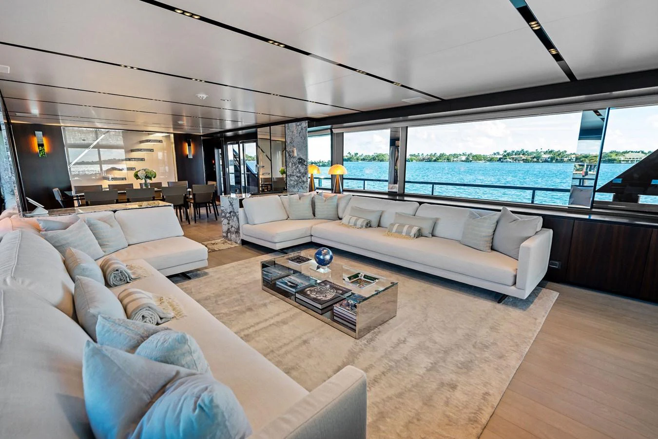 The spacious salon offers panoramic views and luxurious seating arrangements. aboard TENACIOUS Yacht for Sale