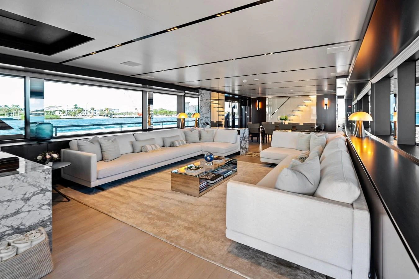 The spacious salon features luxurious seating and panoramic windows offering stunning views. aboard TENACIOUS Yacht for Sale