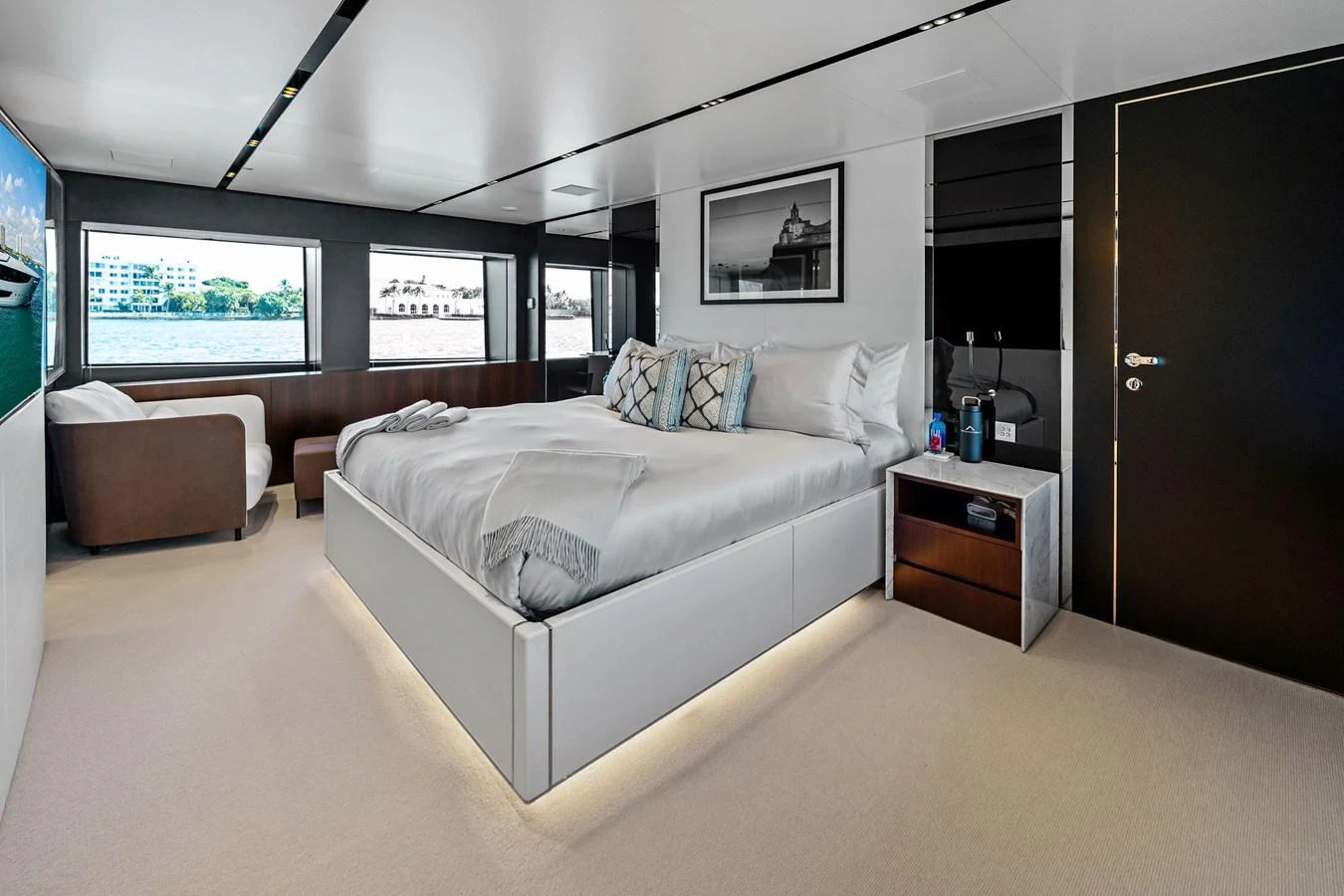 The master stateroom features a luxurious bed with elegant decor and ample natural light. aboard TENACIOUS Yacht for Sale