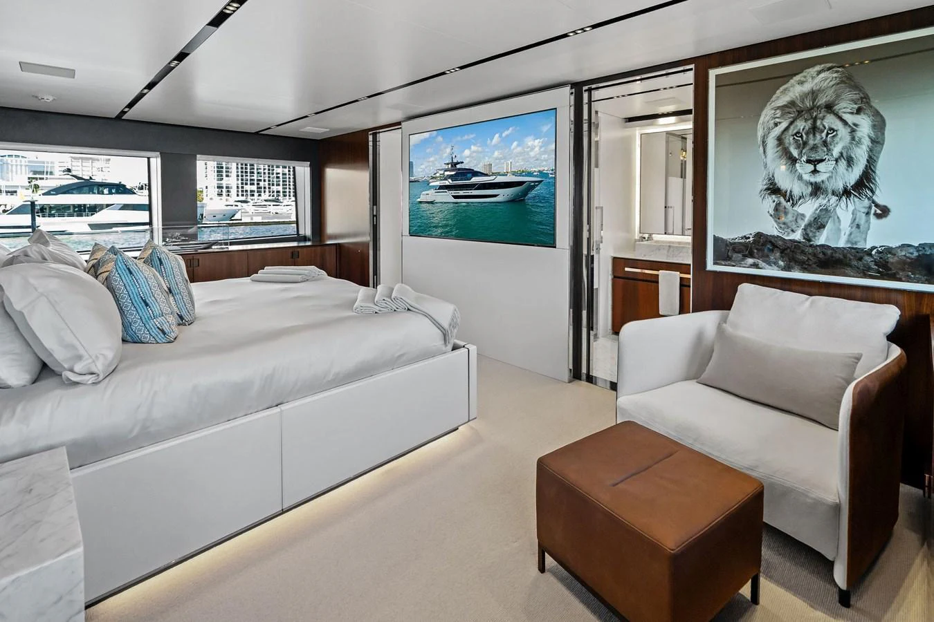 The luxurious stateroom features a spacious bed, elegant seating, and large windows offering stunning views. aboard TENACIOUS Yacht for Sale