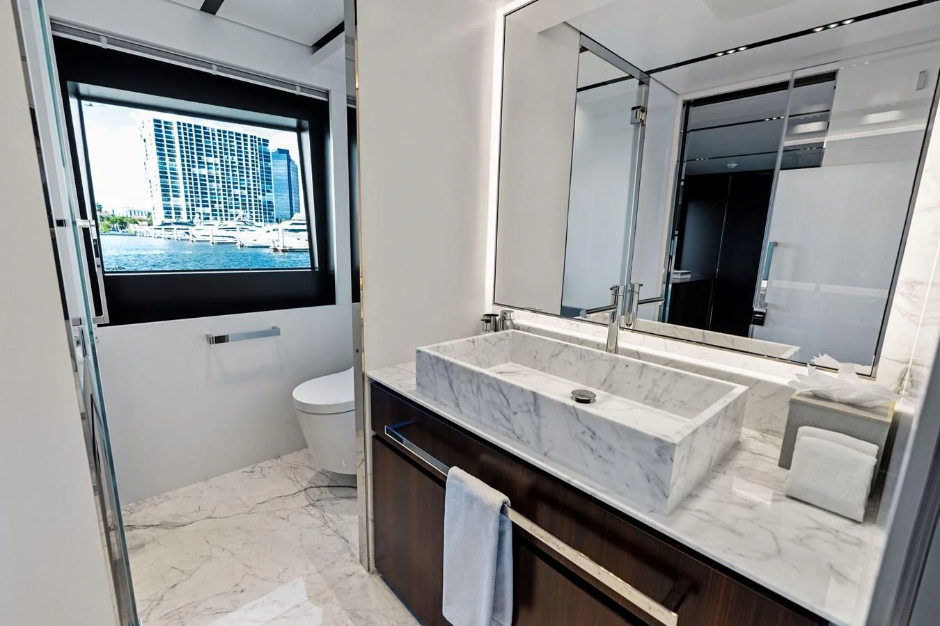 The yacht's bathroom features a sleek design with a marble countertop and modern fixtures. aboard TENACIOUS Yacht for Sale