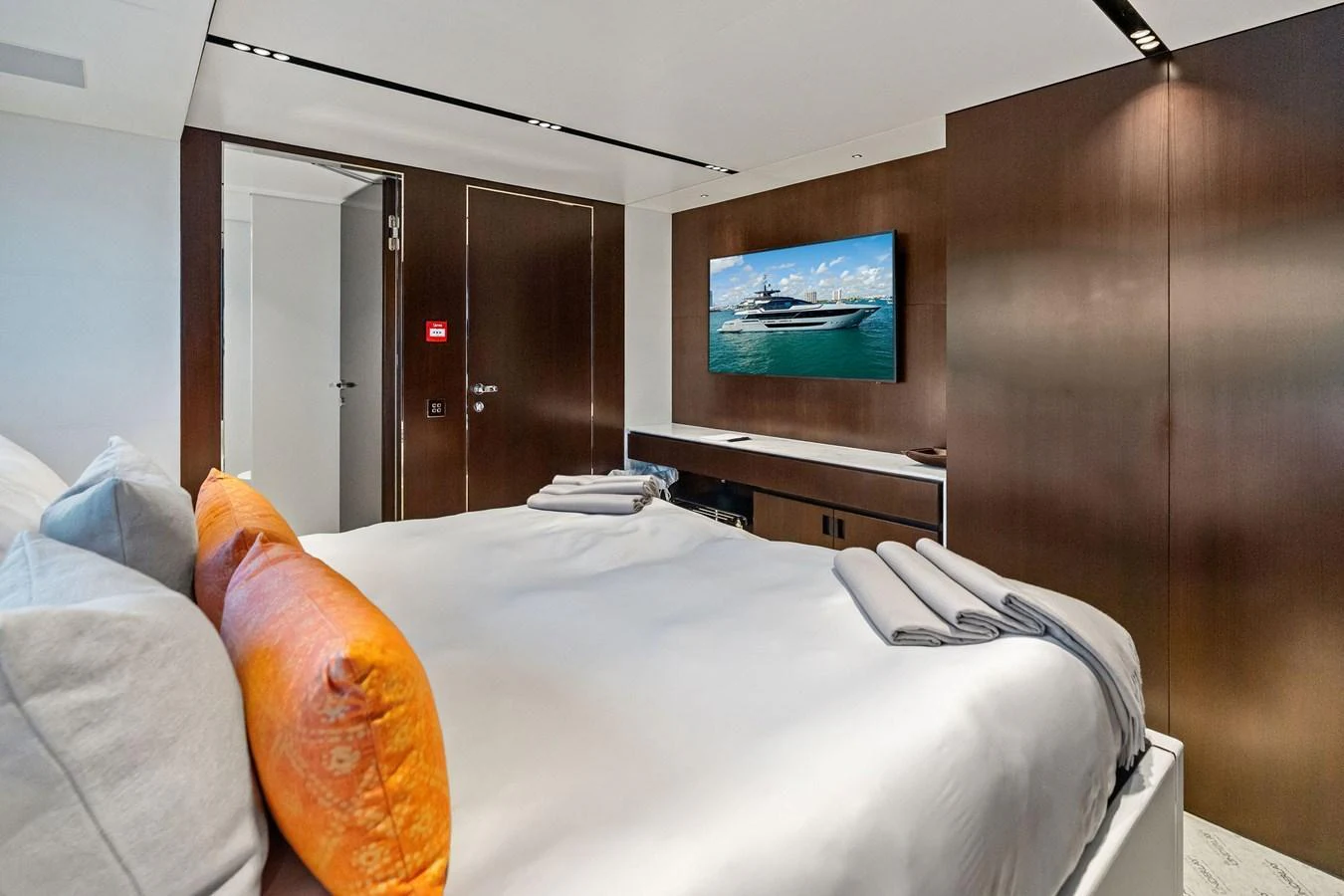 A luxurious stateroom featuring a comfortable bed and modern amenities. aboard TENACIOUS Yacht for Sale