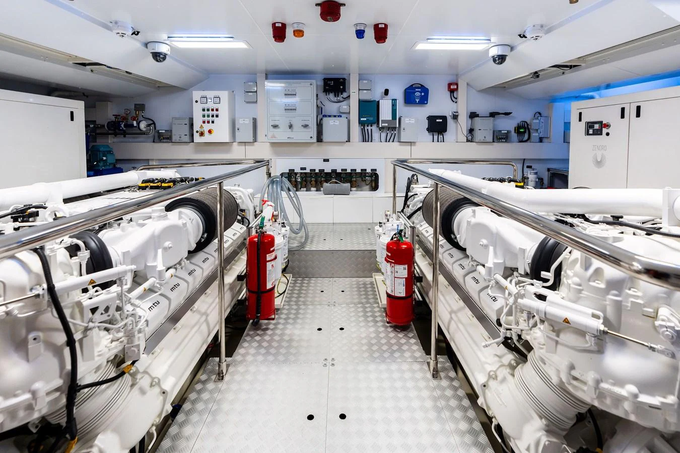 The engine room is meticulously organized with advanced machinery and safety equipment. aboard TENACIOUS Yacht for Sale