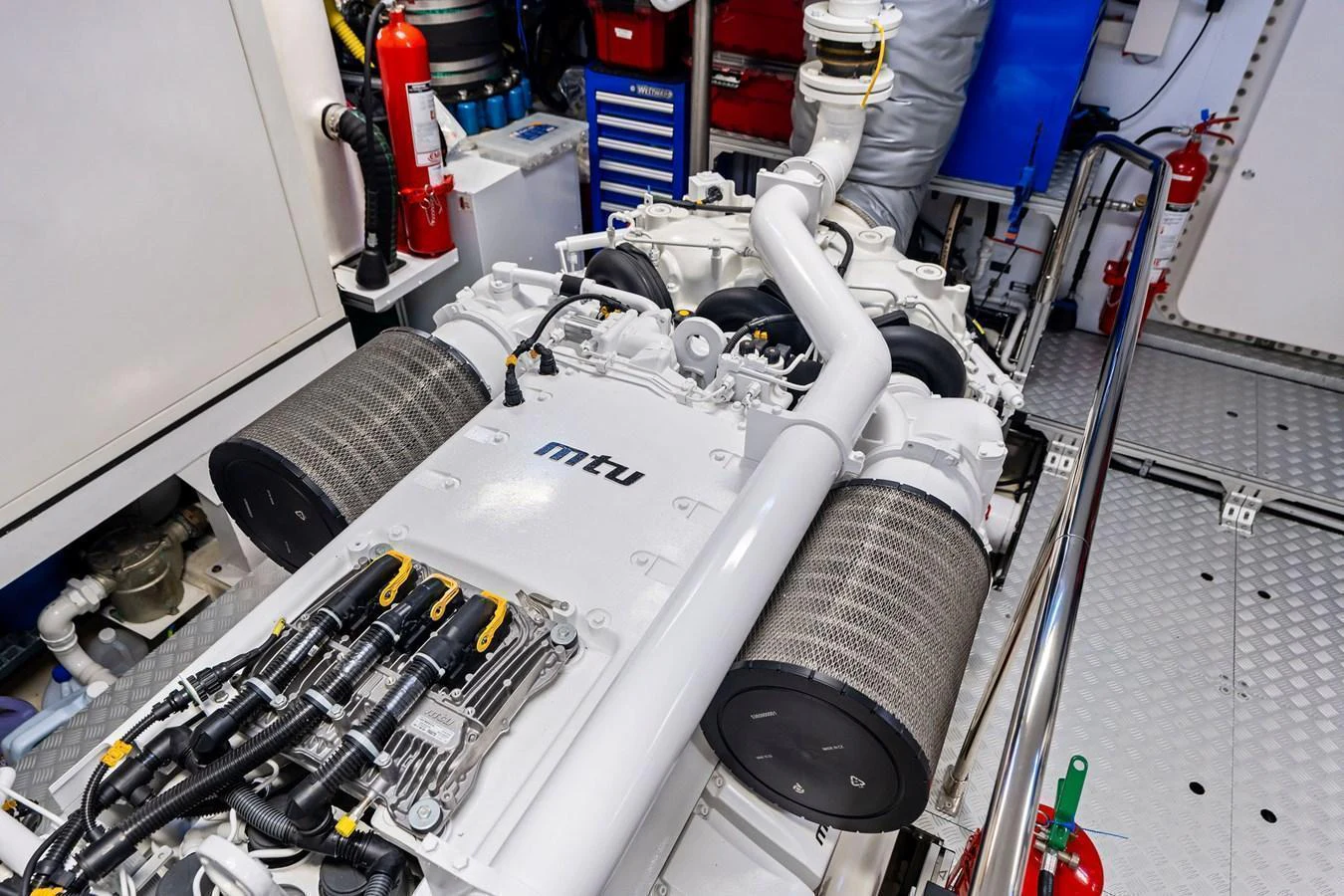 The image showcases the meticulously organized engine room featuring a powerful MTU engine. aboard TENACIOUS Yacht for Sale